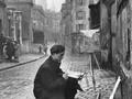 Ed Clark. A young artist paints Sacré-Coeur from the ancient rue Norvins in Montmartre. Paris, 1946.