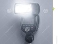A tinted image of a speed light off-camera flash gun firing a burst of light. #camera #dreamstime #photography