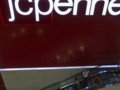 J.C. Penney's quarterly loss halves, set for full-year profit