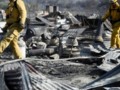 California firefighters make gains after 100 homes destroyed