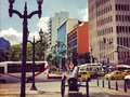 #building #cannon #lamp #palms #building #sky #bus #people #cars #taxi #street PASEO DE BOLÍVAR #downtown #history