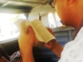 A guy reading a book in a jeepney/car