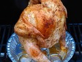 Beer Butt Bird on the grill. Actually this chicken is sitting on a can half full of Bourbon & Ginger Ale while it slowly roasts.