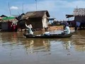 Fishmongers going house to house selling their catch in Chong Kneas - floating city on the Tonle Sap Cambodia