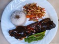 Gal-Bi (Korean style flanken short ribs) with rice, steamed asparagus, and a slaw made of julienned apple, carrot, radishes with a spicy hot and sweet vinaigrette dressing.