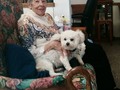 Grandma and Mannie sitting on her new rocking loveseat.