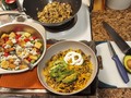 Tonight's Dinner:  Southwestern Stir-Fry Kale-based Chopped Salad  Two leftover halves of Roasted Stuffed Chicken #Breasts - 1w/Spinach & Mushrooms, and 2nd a S.W. Bacon wrap stuffed with peppers & onions in a sour cream enchilada sauce - that was going to top a couple Chef Salads with were detoured to a quick & WARM dinner entree b'cuz I needed a tummy-warming meal to offset the lingering cold symptoms and the cold autumn night. So the leftover chix breasts and Cilantro Lime Rice from the Chicken dinner last week (before I started sucking down big bowls of #ChickenSoup, see earlier Tonight'sDinner posts), added some diced Jalapeños and onions, and a couple handfuls of mushrooms I wanted to use up while still in good shape. While the rice and veggies began stir-frying in Garlic/Chili Seasame oil, I made a chopped salad of kale and romaine with my usual additions of 'maters & cucs, crusty crunchy croutons, and some Gorgonzola crumbles. Then I diced the 2 chicken breast halves and added them to the pan, cranked up the heat, and seared the breasts, then lower heat to medium and stirred in some medium hot Thick&Chunky Salsa Verde, covered pan to simmer while I got my drinks and setup dinner tray. Serving up some of the Southwest Stir-Fry I sprinkled it with shredded Medium Cheddar, gave it a squirt of sour cream, and topped with some slices of fresh ripe Avocado. 😋 #yummy! 😋  This made dinner for two, or in my case two-nights dinner. #TonightsDinner  #Southwest #Stirfry
