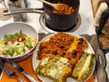 Tonight's Dinner:  Mexican Fiesta Platter (from bottom of plate then clockwise)  Baked Poblano Chile Relleno Mexican Rice Chili Beans Chicken Enchilada in Hatch Chili Rojo sauce Roasted Stuffed Jalapeño Hearty Tossed Salad ¡Olé! ok, I'm a month late for El Grito (Mexican Independence Day [from Spain] not to be confused with the later Cinco de Mayo) but I found a couple Poblanos and half dozen Jalapeño chilies in my Co-op box yesterday so I was pondering Chile Rellenos ... fired up the grill and roasted the Poblanos and Jalapeños. After cooling in a heavy bag for an hour, I skinned and seeded the chilies. I stuffed the Jalapeños with #StringCheese sticks, then breaded with Panko before quickly deep frying for 2 mintues. The Poblanos were stuffed with #Queso #Oaxaca (you can sub Monterrey Jack). I layered a small baking dish with first a mix of panko and Queso #Cojita (sort of Mexican equivalent of Parmesan cheese), then poured in some beaten eggs to jus bread crumbs, then dusted stuffed Poblanos with flour and layed them over eggs and bread crumbs, sprinkle another layer of Panko and Cojita, sprinkle with extra Cojita, then pour in enough beaten eggs to jus all the layers, and bake for 45 minutes.  The Enchiladas were made with Mexican spiced and braised chicken breast, then shredded, some Hatch Rojo sauce stirred in along with diced onions and shredded cheese of choice (I used some if the Oaxaca), then fill tortillas, place in baking dish, smoother in Hatch Rojo sauce, sprinkle with more shredded cheese and bake 30 minutes. Warm up Pinto Beans with diced onions and Jalapeños, 3-4 cloves garlic, chili powder and cuminos. Steam some rice (ideally a day or two ahead of time), stir-fry some diced onions, jalapeños, tomato, minced garlic, add rice and spices - chili powder, cuminos, oregano - stir well then lower heat and cover. To serve, cut desired portions of Poblano Relleno and Enchilada garnished with sliced scallions and black olives, a scoop each of rice and beans, and 1 or 2 of the Jalapeño Poppers, top Relleno and Enchilada with some sour cream and guacamole. Enjoy! #TonightsDinner  #Mexican #ChiliRelleno #JalapenoPoppers