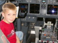 Little boy in the cockpit of a large airplane
